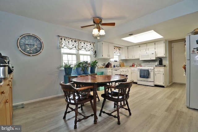2028 Brookdale Dr, Forked River, NJ 08731 - dining room with a skylight, light wood finished floors, ceiling fan, and baseboards