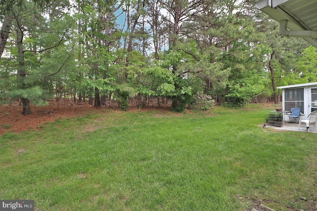 2028 Brookdale Dr, Forked River, NJ 08731 - view of grassy yard with a patio area and a sunroom