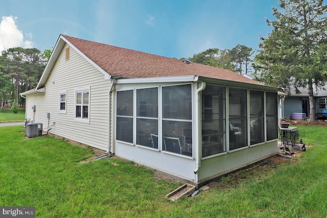 2028 Brookdale Dr, Forked River, NJ 08731 - view of side of property with a sunroom, a shingled roof, and a lawn