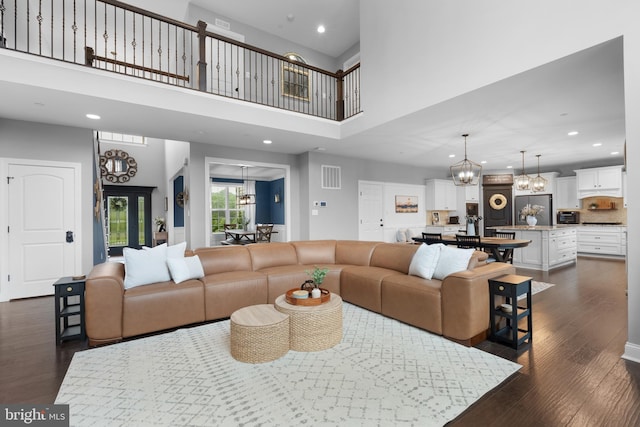 815 Summersweet Ct, Huntingtown, MD 20639 - living area with a chandelier, a towering ceiling, recessed lighting, and dark wood-style floors