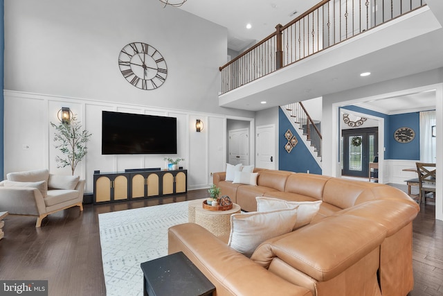 815 Summersweet Ct, Huntingtown, MD 20639 - living area featuring a decorative wall, a high ceiling, stairs, wood finished floors, and wainscoting