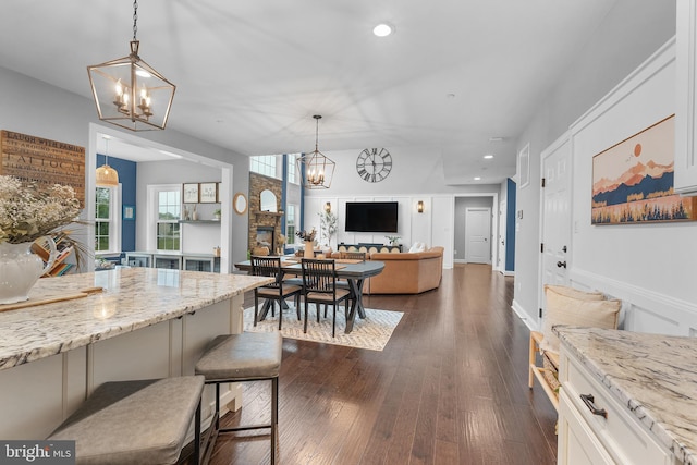 815 Summersweet Ct, Huntingtown, MD 20639 - kitchen with a chandelier, recessed lighting, light stone countertops, and a breakfast bar area