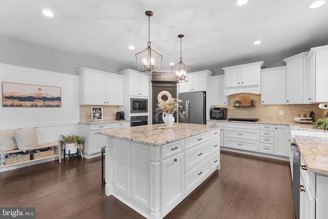 815 Summersweet Ct, Huntingtown, MD 20639 - kitchen featuring black appliances, backsplash, white cabinetry, recessed lighting, and a kitchen island