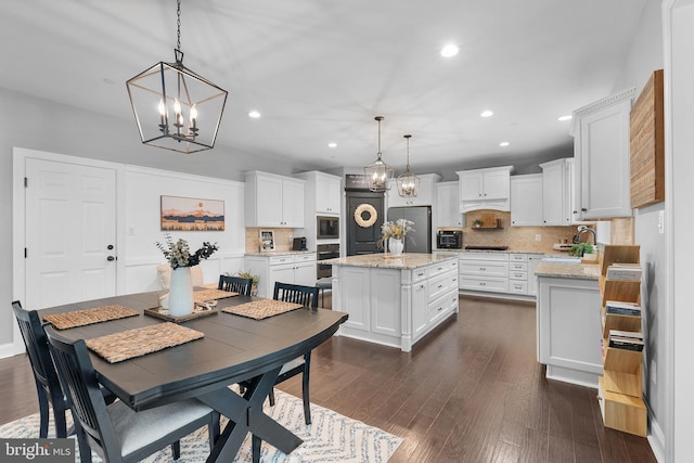 815 Summersweet Ct, Huntingtown, MD 20639 - dining space with recessed lighting, a chandelier, and dark wood finished floors