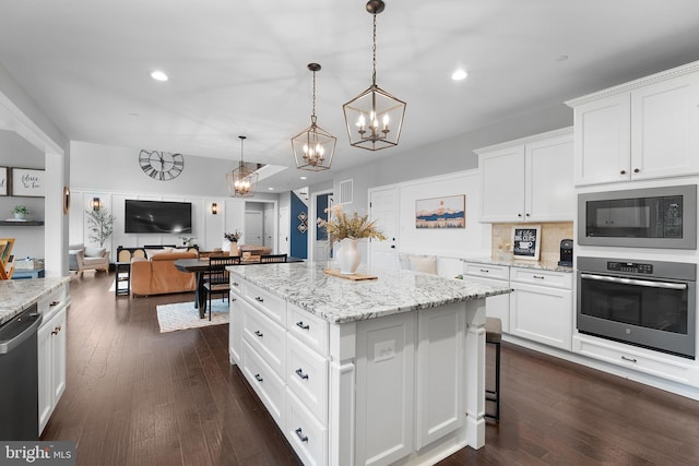 815 Summersweet Ct, Huntingtown, MD 20639 - kitchen with stainless steel appliances, a chandelier, white cabinets, a kitchen island, and open floor plan