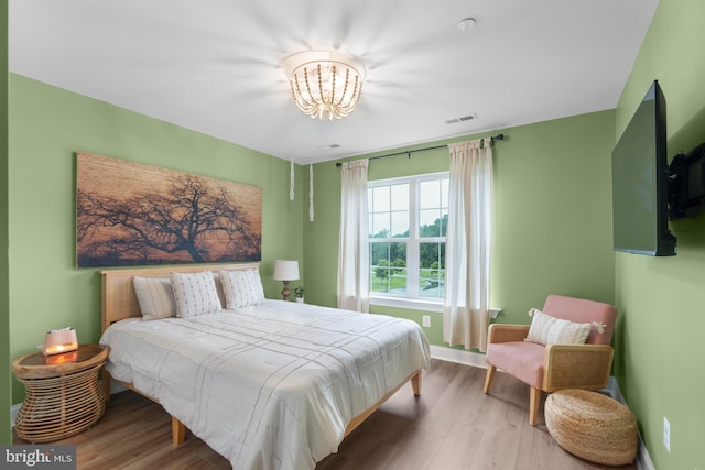 815 Summersweet Ct, Huntingtown, MD 20639 - bedroom featuring a chandelier, wood finished floors, and baseboards