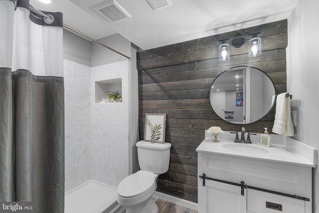 815 Summersweet Ct, Huntingtown, MD 20639 - full bathroom with vanity, toilet, a tile shower, wood finished floors, and wood walls