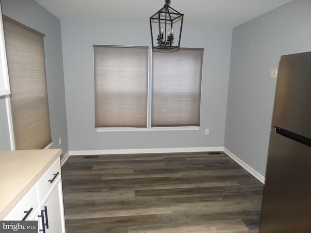 112 Colton Ct, Smithsburg, MD 21783 - unfurnished dining area with a chandelier, dark wood-style flooring, and baseboards