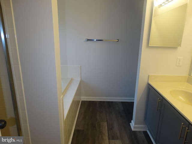 112 Colton Ct, Smithsburg, MD 21783 - bathroom featuring vanity, wood finished floors, baseboards, and tiled bath