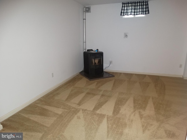 112 Colton Ct, Smithsburg, MD 21783 - below grade area with carpet floors, a wood stove, and baseboards