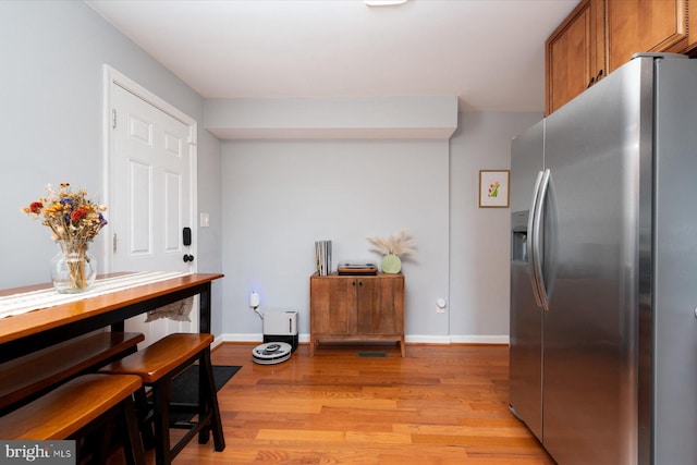 1005 Madison Ct, Annapolis, MD 21403 - kitchen with stainless steel fridge, light wood-style flooring, baseboards, and brown cabinetry