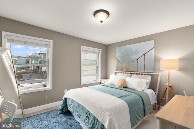 3234 Odonnell St, Baltimore, MD 21224 - carpeted bedroom featuring multiple windows and baseboards