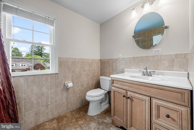 1 Carriage Way, Cinnaminson, NJ 08077 - bathroom with tile walls, plenty of natural light, toilet, vanity, and a wainscoted wall