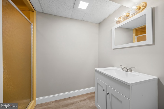 1 Carriage Way, Cinnaminson, NJ 08077 - bathroom with wood finished floors, a drop ceiling, vanity, baseboards, and a shower with door