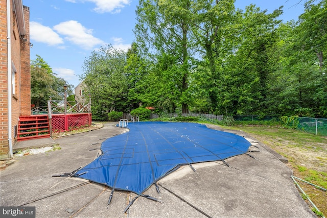1 Carriage Way, Cinnaminson, NJ 08077 - view of swimming pool featuring a deck, a fenced backyard, a patio area, and view of wooded area