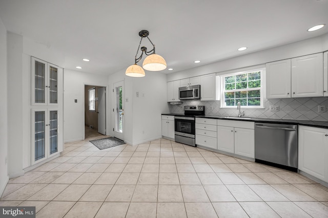1 Carriage Way, Cinnaminson, NJ 08077 - kitchen featuring appliances with stainless steel finishes, a sink, dark countertops, decorative backsplash, and white cabinetry