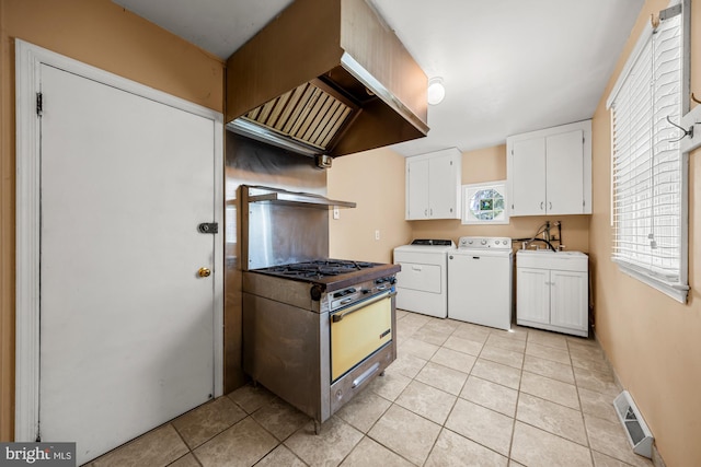 1 Carriage Way, Cinnaminson, NJ 08077 - kitchen with washer and dryer, white cabinetry, light tile patterned floors, and gas stove