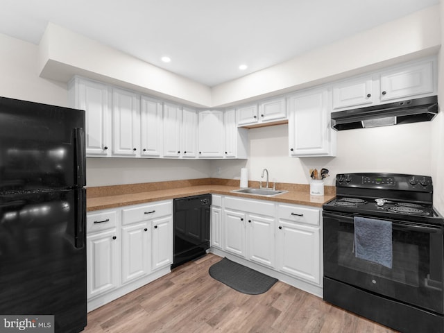 11 E Avon Dr Unit E, Hightstown, NJ 08520 - kitchen featuring black appliances, under cabinet range hood, a sink, white cabinetry, and light wood-style flooring