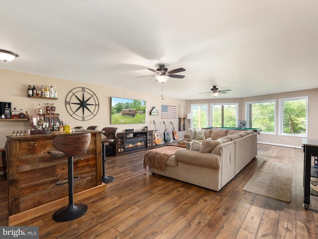 1439 Fiery Run Rd, Linden, VA 22642 - living area with dark wood-style flooring, a dry bar, a ceiling fan, and a glass covered fireplace