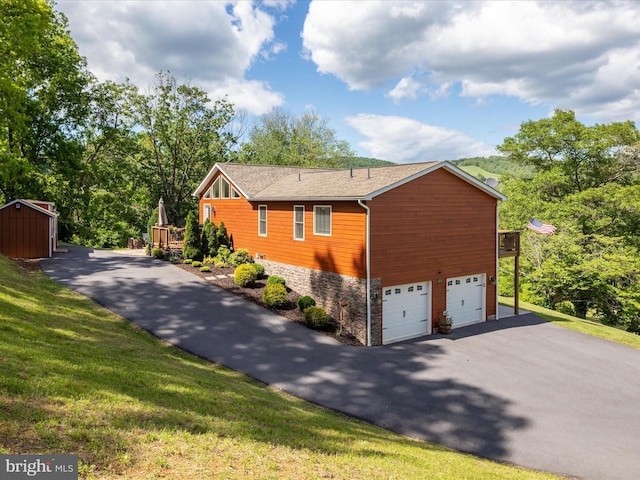 1439 Fiery Run Rd, Linden, VA 22642 - view of side of home with asphalt driveway, a garage, stone siding, a deck, and a yard