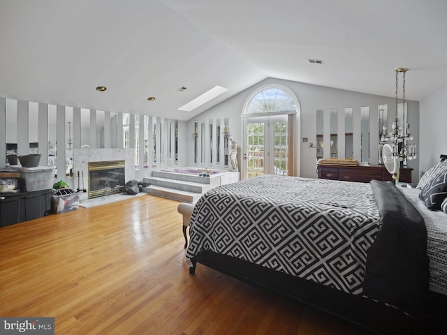 4326 Ranger Ave, Temple Hills, MD 20748 - bedroom with wood finished floors, vaulted ceiling, a fireplace, and a skylight