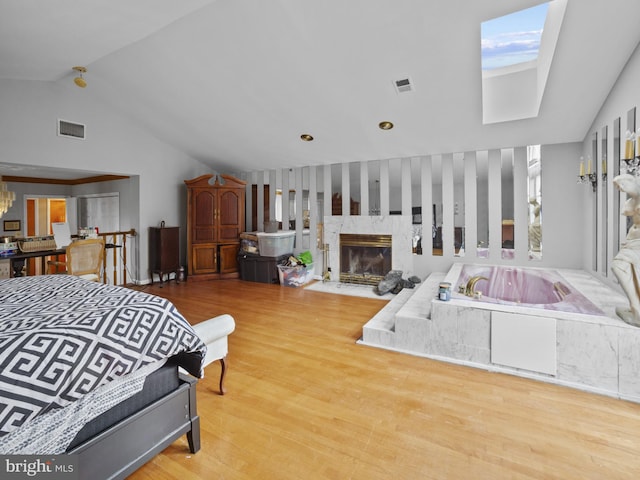4326 Ranger Ave, Temple Hills, MD 20748 - bedroom with a premium fireplace, wood finished floors, a skylight, and high vaulted ceiling