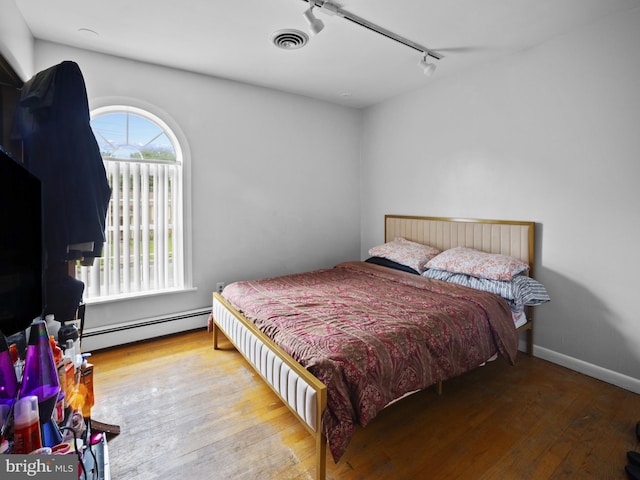 4326 Ranger Ave, Temple Hills, MD 20748 - bedroom featuring track lighting, baseboard heating, and wood-type flooring