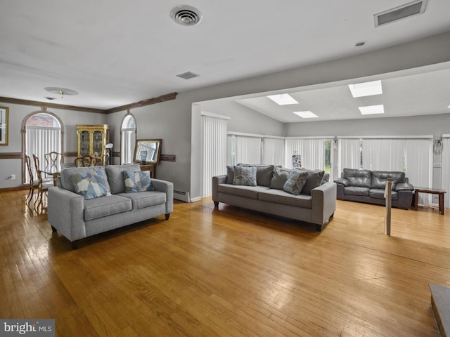 4326 Ranger Ave, Temple Hills, MD 20748 - living area with a skylight, light wood finished floors, and a baseboard radiator