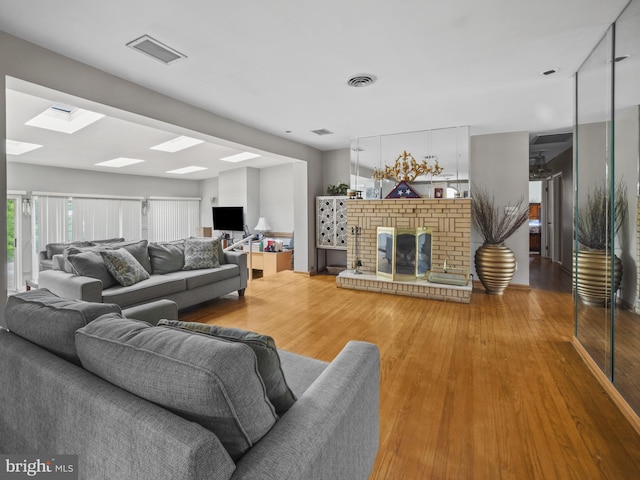 4326 Ranger Ave, Temple Hills, MD 20748 - living area with a skylight, wood finished floors, and a fireplace