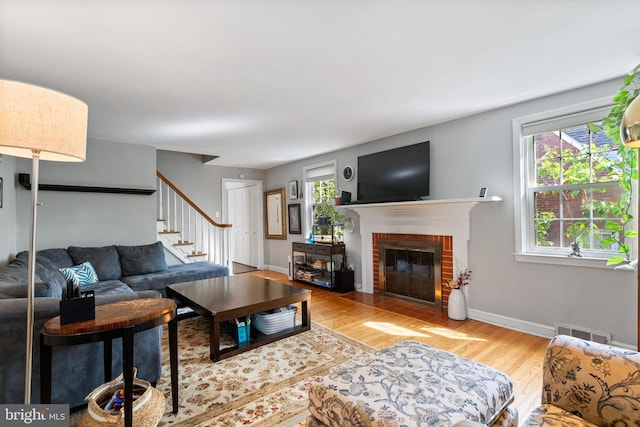 915 Edgewood Dr, Springfield, PA 19064 - living area featuring stairs, wood finished floors, a fireplace, and baseboards
