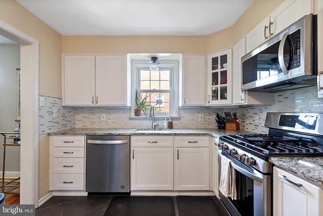 915 Edgewood Dr, Springfield, PA 19064 - kitchen featuring stainless steel appliances, a sink, white cabinetry, dark marble finish floors, and light stone countertops