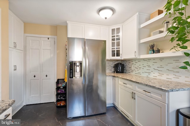 915 Edgewood Dr, Springfield, PA 19064 - kitchen with stainless steel refrigerator with ice dispenser, open shelves, white cabinetry, and decorative backsplash