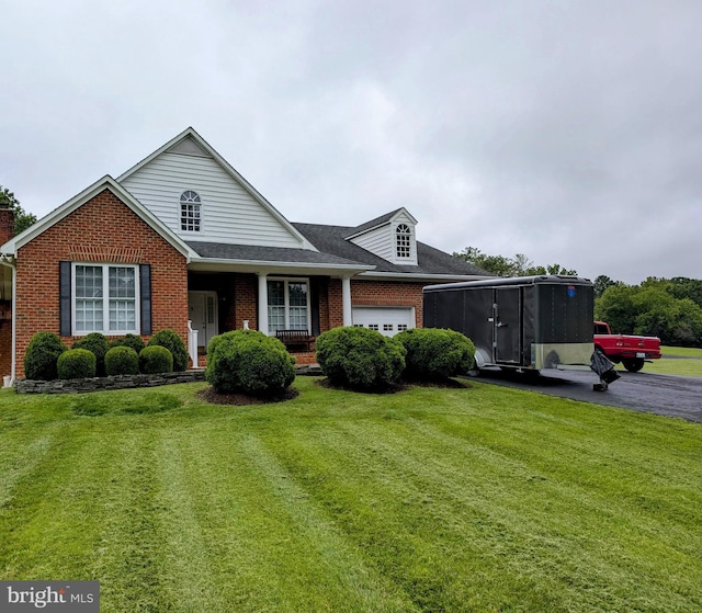 7054 Lakeview Dr, Warrenton, VA 20187 - traditional home featuring brick siding, a garage, a front lawn, and covered porch