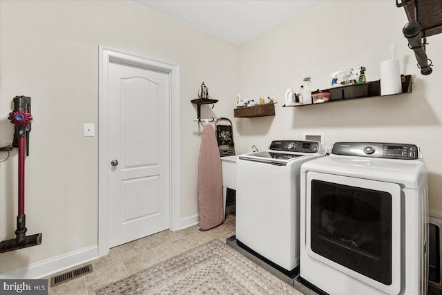 3525 Franks Ter, Monrovia, MD 21770 - laundry area featuring washing machine and clothes dryer, baseboards, and light tile patterned floors