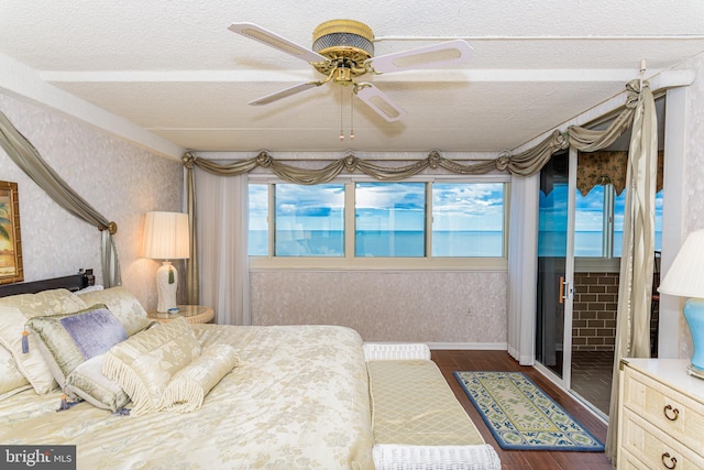 10300 Coastal Hwy Unit 1905, Ocean City, MD 21842 - bedroom with dark wood-style floors, wallpapered walls, a textured ceiling, a ceiling fan, and baseboards