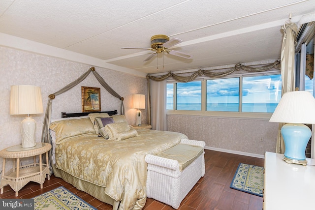 10300 Coastal Hwy Unit 1905, Ocean City, MD 21842 - bedroom featuring wallpapered walls, wood finished floors, baseboards, a textured ceiling, and a ceiling fan