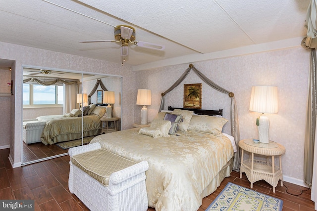10300 Coastal Hwy Unit 1905, Ocean City, MD 21842 - bedroom with wallpapered walls, baseboards, a textured ceiling, wood finished floors, and ceiling fan