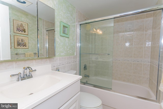 10300 Coastal Hwy Unit 1905, Ocean City, MD 21842 - bathroom featuring toilet, vanity, enclosed tub / shower combo, and tile walls