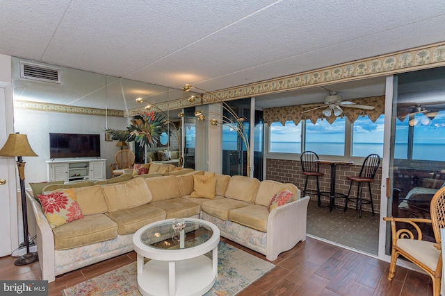 10300 Coastal Hwy Unit 1905, Ocean City, MD 21842 - living room featuring wood finished floors, a ceiling fan, and a textured ceiling