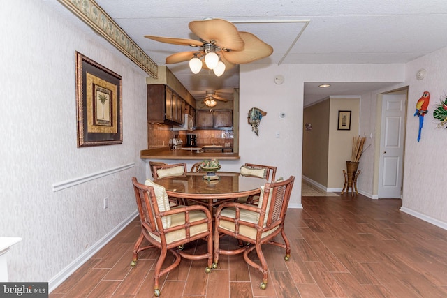 10300 Coastal Hwy Unit 1905, Ocean City, MD 21842 - dining area featuring wood finished floors, a ceiling fan, wallpapered walls, and baseboards