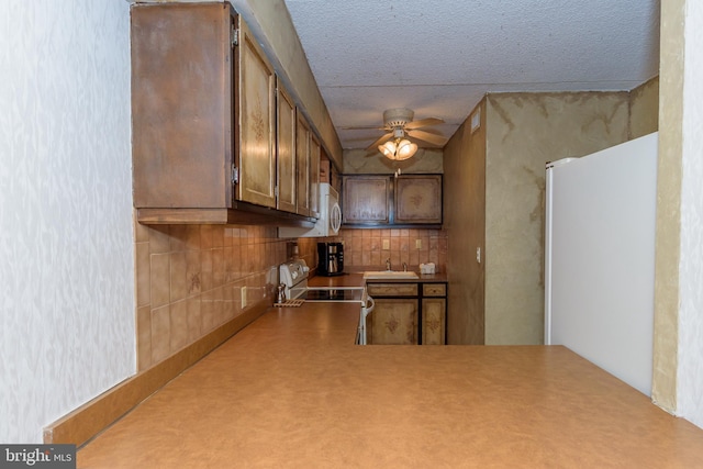 10300 Coastal Hwy Unit 1905, Ocean City, MD 21842 - kitchen featuring a ceiling fan, range with electric cooktop, backsplash, a sink, and white microwave