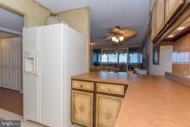10300 Coastal Hwy Unit 1905, Ocean City, MD 21842 - kitchen with white refrigerator with ice dispenser, ceiling fan, light tile patterned floors, premium range hood, and light countertops