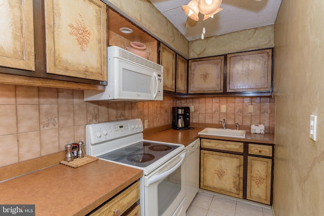 10300 Coastal Hwy Unit 1905, Ocean City, MD 21842 - kitchen with white appliances, a sink, decorative backsplash, light tile patterned floors, and brown cabinetry