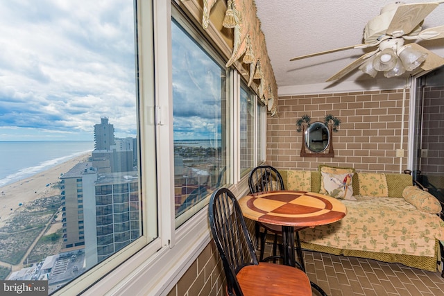 10300 Coastal Hwy Unit 1905, Ocean City, MD 21842 - dining area featuring a ceiling fan, view of water and beach, and brick patterned flooring