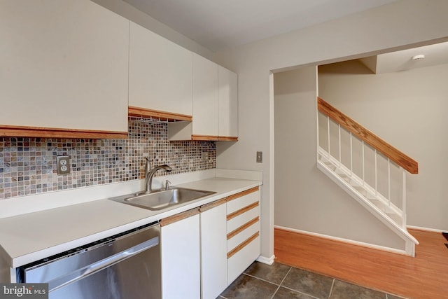 1364 Almond Dr, Annapolis, MD 21409 - kitchen with stainless steel dishwasher, a sink, light countertops, white cabinets, and backsplash