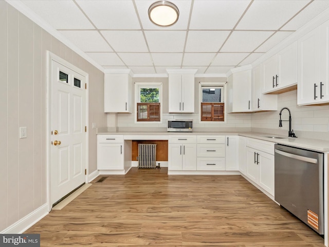 1707 Hall Ave, Baltimore, MD 21227 - kitchen with appliances with stainless steel finishes, white cabinets, ornamental molding, light wood-style floors, and decorative backsplash