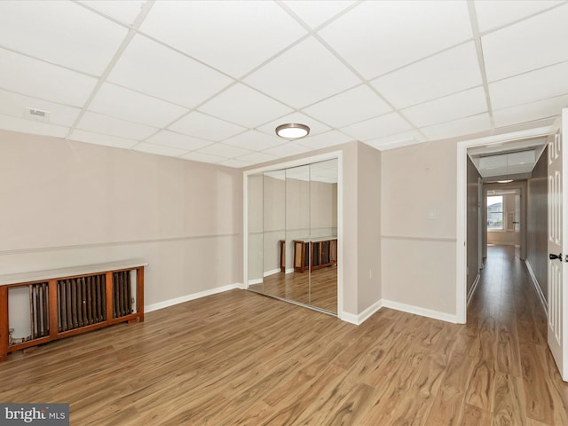 1707 Hall Ave, Baltimore, MD 21227 - unfurnished living room featuring a drop ceiling and wood finished floors