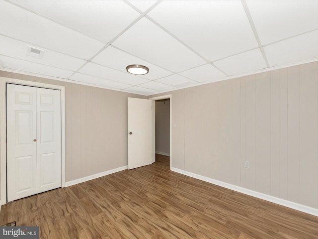 1707 Hall Ave, Baltimore, MD 21227 - unfurnished bedroom featuring wood finished floors, a paneled ceiling, and a closet
