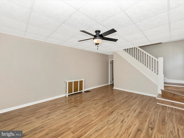 1707 Hall Ave, Baltimore, MD 21227 - unfurnished living room with wood finished floors, stairway, ceiling fan, and a drop ceiling
