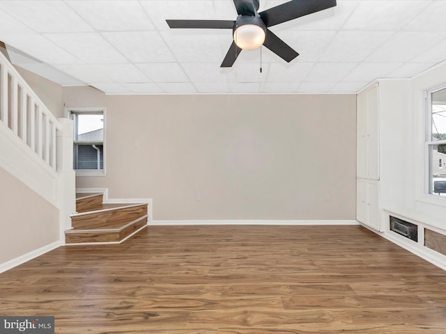 1707 Hall Ave, Baltimore, MD 21227 - spare room featuring stairway, wood finished floors, a paneled ceiling, and a ceiling fan